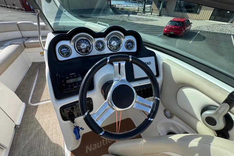 Slide: The Image of 2017 NauticStar 243DC Sport Deck boat dashboard with steering wheel and gauges. - 12