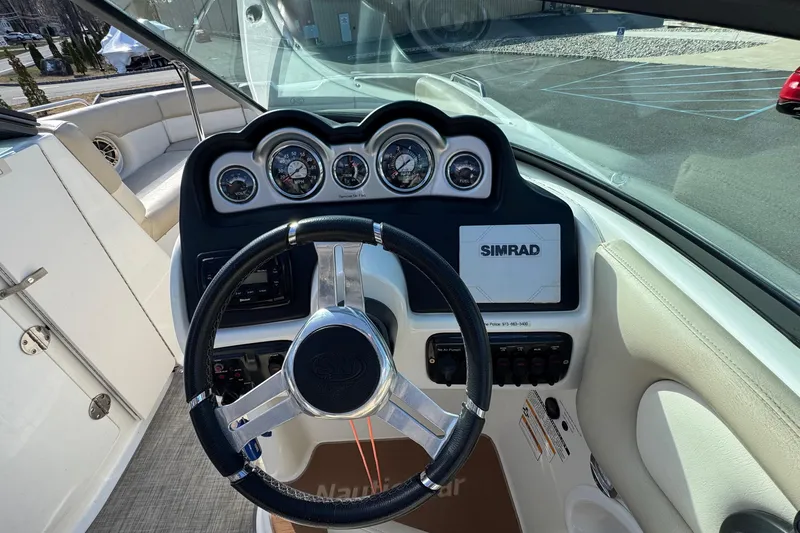Slide: The Image of 2017 NauticStar 243DC Sport Deck helm with steering wheel and Simrad display. - 13
