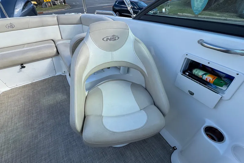 Slide: The Image of 2017 NauticStar 243DC Sport Deck boat interior with seating and storage compartment. - 14