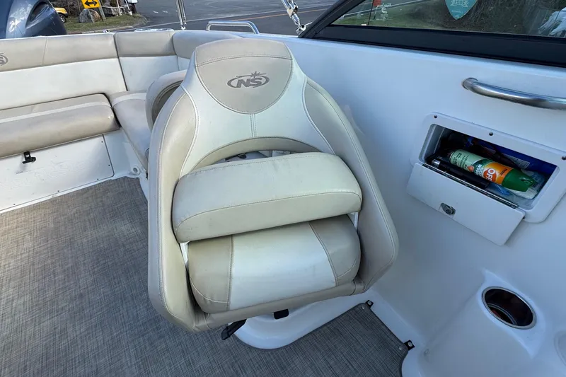 Slide: The Image of 2017 NauticStar 243DC Sport Deck boat interior with seating and storage compartment. - 15