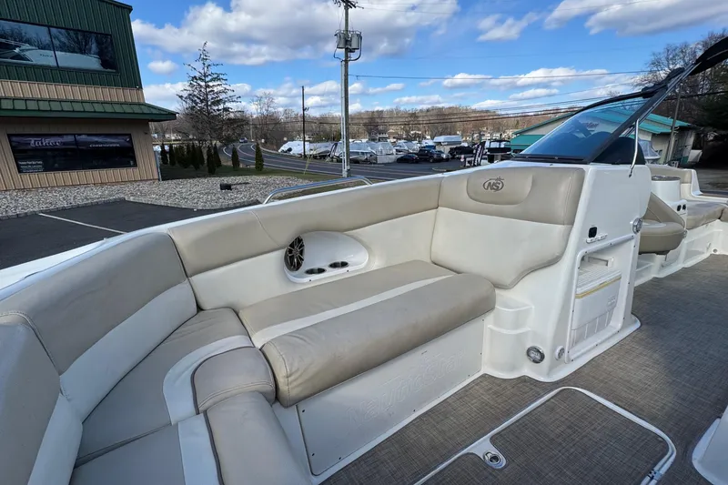 Slide: The Image of 2017 NauticStar 243DC Sport Deck boat interior with beige seating and speaker. - 21