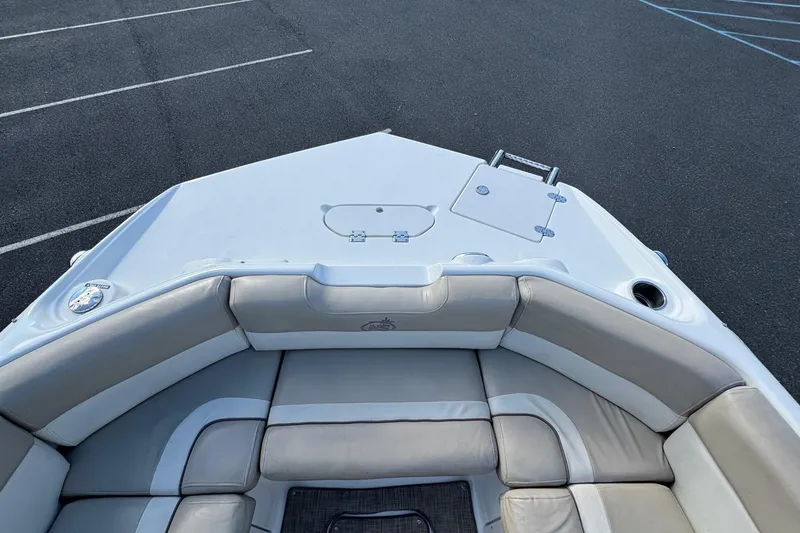 Slide: The Image of 2017 NauticStar 243DC Sport Deck boat with cushioned seating and storage compartments. - 22