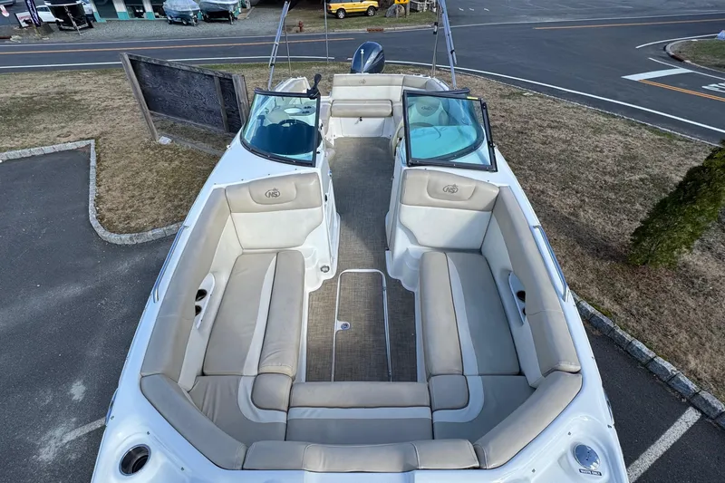 Slide: The Image of 2017 NauticStar 243DC Sport Deck boat with spacious seating and open deck layout. - 23