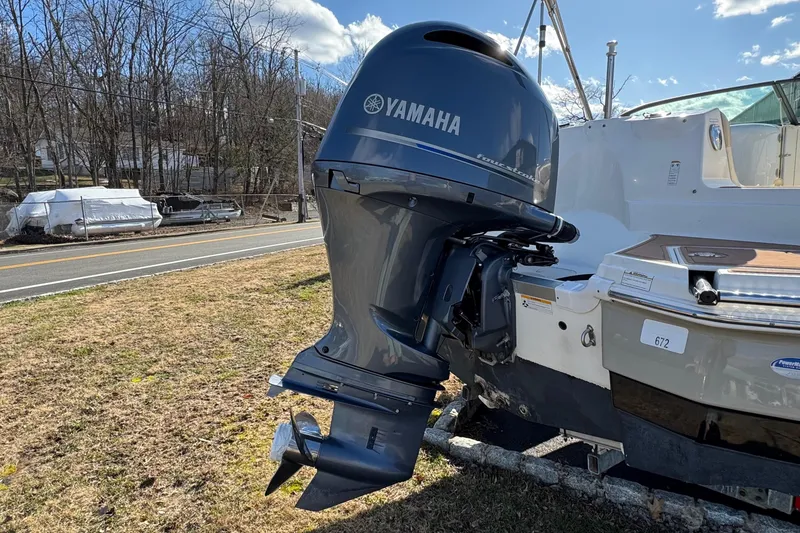 Slide: The Image of 2017 NauticStar 243DC Sport Deck with Yamaha outboard motor, parked on grass. - 24