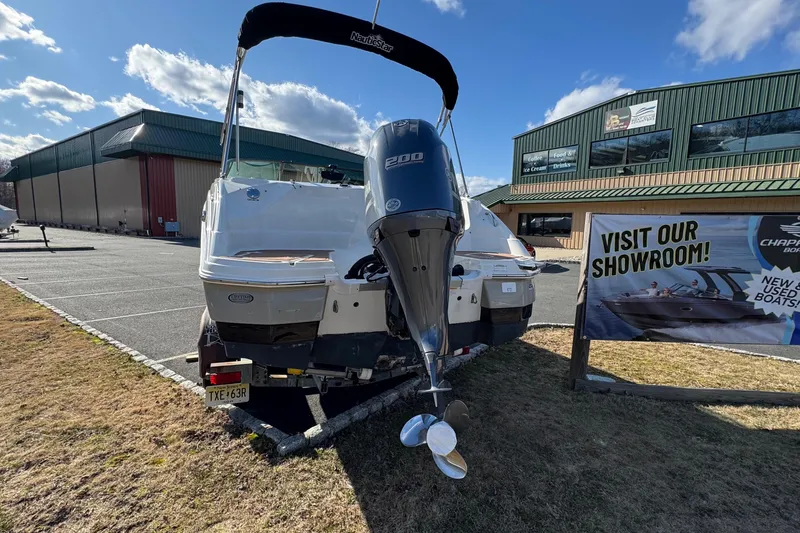 Slide: The Image of 2017 NauticStar 243DC Sport Deck boat displayed outside showroom with Yamaha engine. - 27