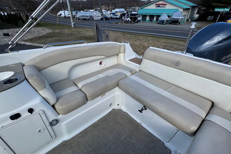 Slide: The Image of 2017 NauticStar 243DC Sport Deck boat interior with beige seating and cup holder. - 5