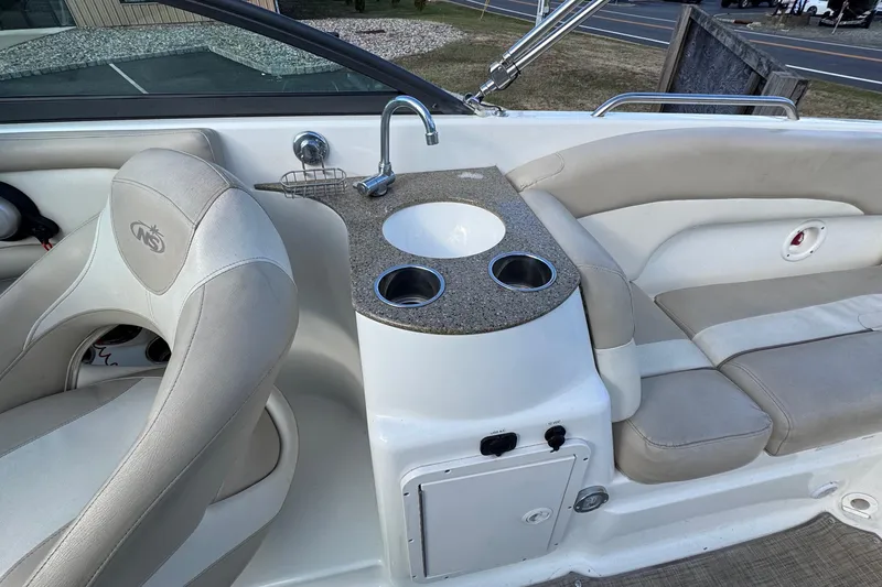 Slide: The Image of 2017 NauticStar 243DC Sport Deck interior with sink and seating area. - 7