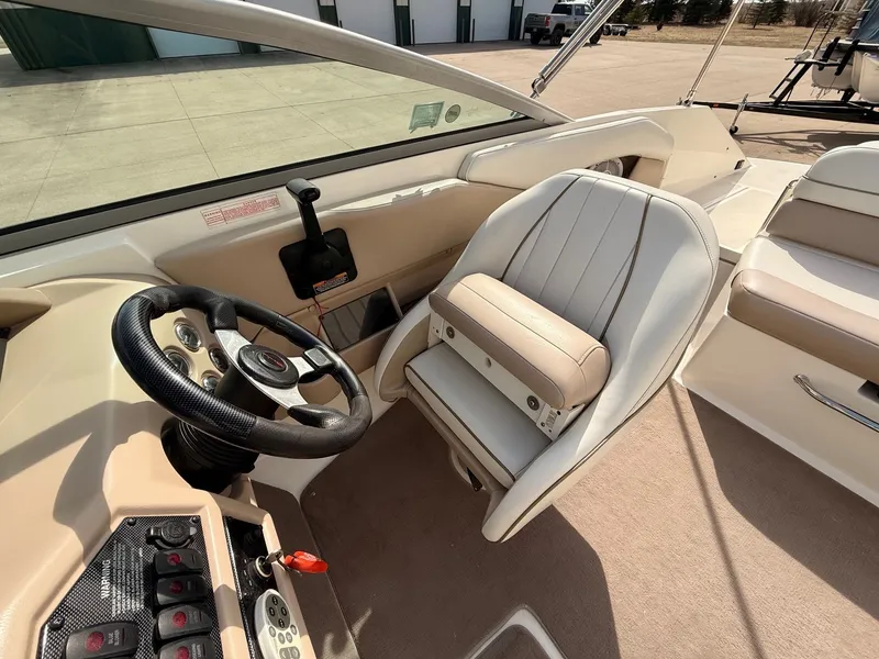 Slide: The Image of Interior of a 2003 Regal 2000 Bowrider boat with steering wheel and seat. - 10