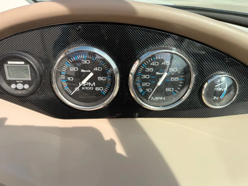 Slide: The Image of Dashboard of a 2003 Regal 2000 Bowrider boat with gauges. - 16