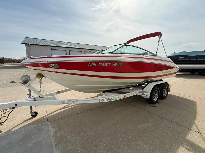 Slide: The Image of 2003 Regal 2000 Bowrider boat on trailer, red and white. - 2