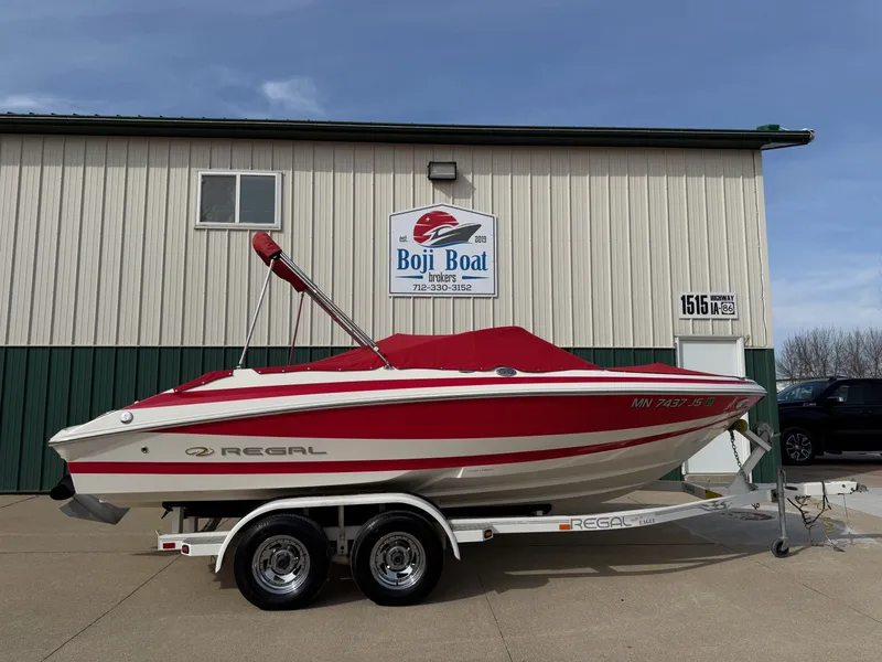 Slide: The Image of 2003 Regal 2000 Bowrider boat in front of Boji Boat building. - 30