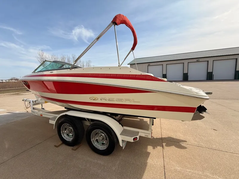 Slide: The Image of 2003 Regal 2000 Bowrider boat on trailer, red and white design. - 4
