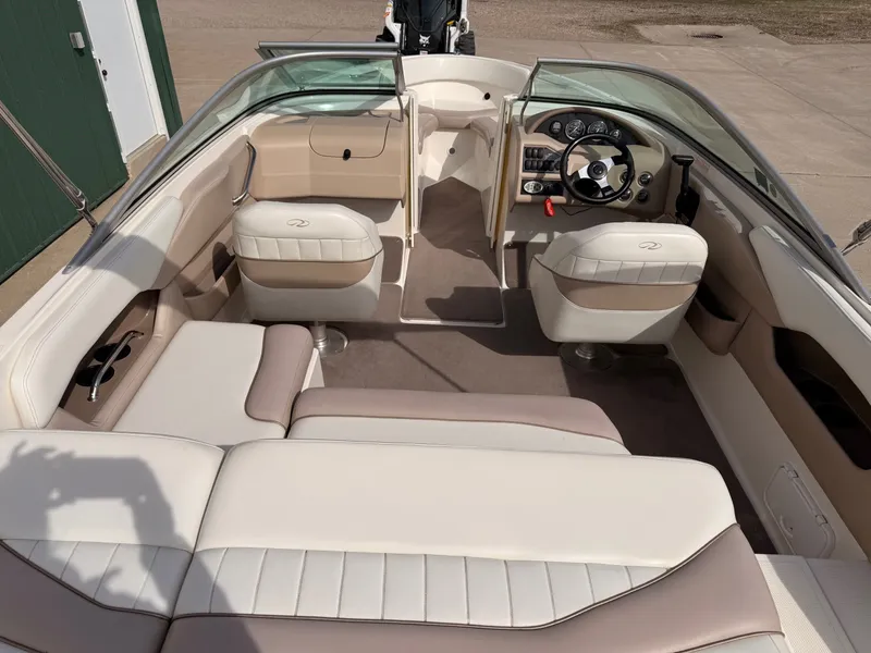 Slide: The Image of Interior of a 2003 Regal 2000 Bowrider boat, beige and white seating. - 6