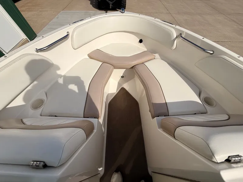Slide: The Image of Interior view of a 2003 Regal 2000 Bowrider boat with beige seating. - 7