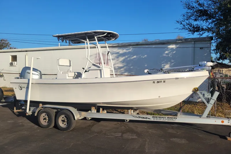 The Image of 2022 C-Hawk 220 Center Console boat on trailer, parked outdoors. - 1