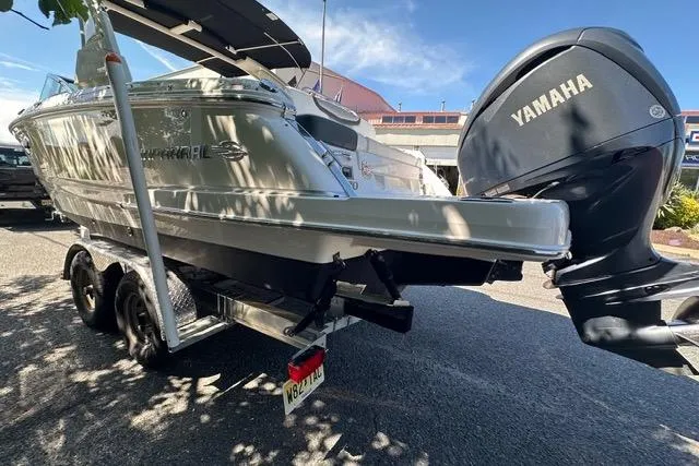 Slide: The Image of 2023 Chaparral 270 OSX boat with Yamaha engine on a trailer, parked outdoors. - 11