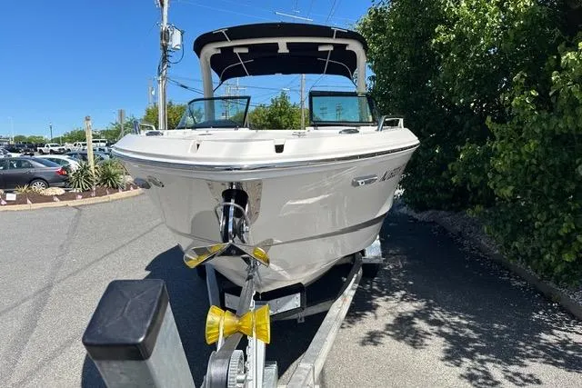 Slide: The Image of 2023 Chaparral 270 OSX boat on trailer, parked outdoors, sunny day. - 12