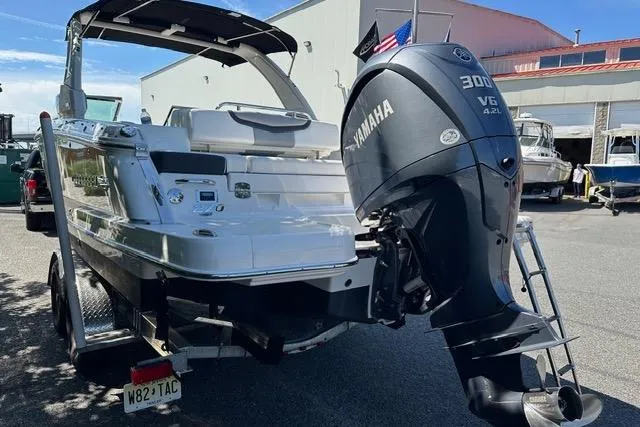 Slide: The Image of 2023 Chaparral 270 OSX boat with Yamaha 300 V6 engine, parked outdoors. - 13