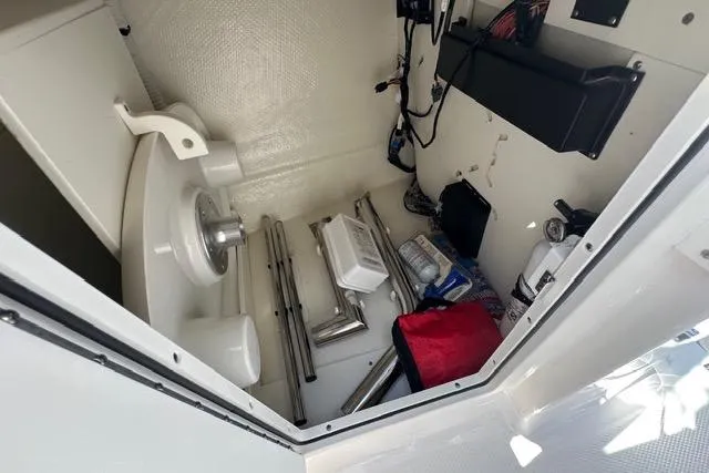 Slide: The Image of Storage compartment of 2023 Chaparral 270 OSX boat with equipment and supplies. - 18