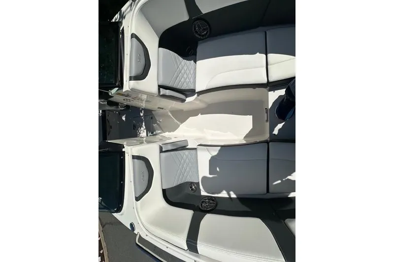 Slide: The Image of 2023 Chaparral 270 OSX boat interior with sleek white and gray seating design. - 19