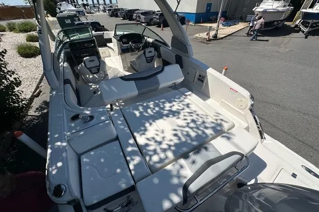 Slide: The Image of 2023 Chaparral 270 OSX boat interior with spacious seating and modern dashboard. - 22