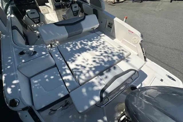 Slide: The Image of 2023 Chaparral 270 OSX boat interior with seating and modern design features. - 23
