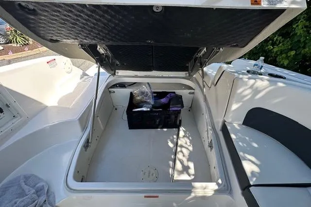Slide: The Image of Open storage compartment in 2023 Chaparral 270 OSX boat, featuring spacious interior and organized storage. - 24