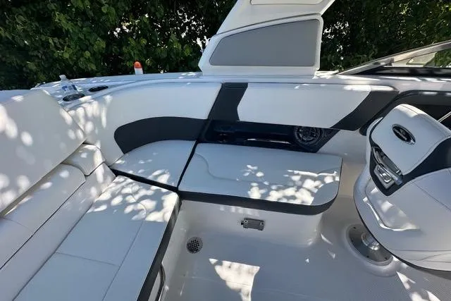 Slide: The Image of 2023 Chaparral 270 OSX boat interior with sleek white seating and modern design. - 27