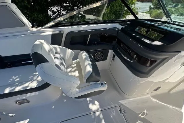 Slide: The Image of 2023 Chaparral 270 OSX boat interior with sleek helm and comfortable seating. - 28