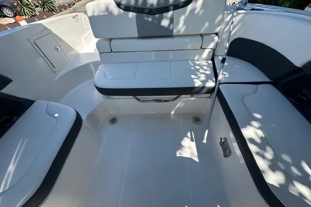 Slide: The Image of 2023 Chaparral 270 OSX boat interior with white seating and sleek design. - 31