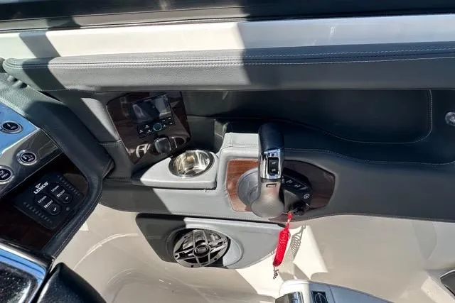 Slide: The Image of Interior view of 2023 Chaparral 270 OSX boat cockpit with controls and cup holder. - 32