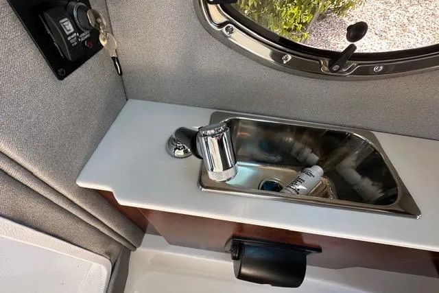 Slide: The Image of 2023 Chaparral 270 OSX boat interior with sink and faucet detail. - 34