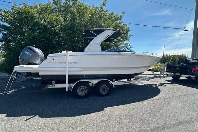 Slide: The Image of 2023 Chaparral 270 OSX boat on trailer, parked outdoors under clear sky. - 4