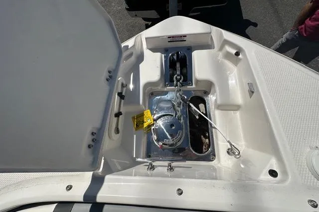 Slide: The Image of 2023 Chaparral 270 OSX boat anchor compartment with open hatch. - 41