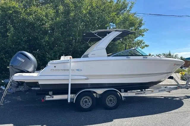 Slide: The Image of 2023 Chaparral 270 OSX boat on trailer with Yamaha outboard, parked outdoors. - 5