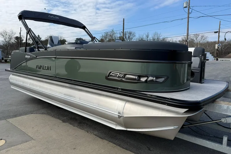 Slide: The Image of 2026 Avalon Catalina Elite 23 pontoon boat with sleek design on a trailer. - 6