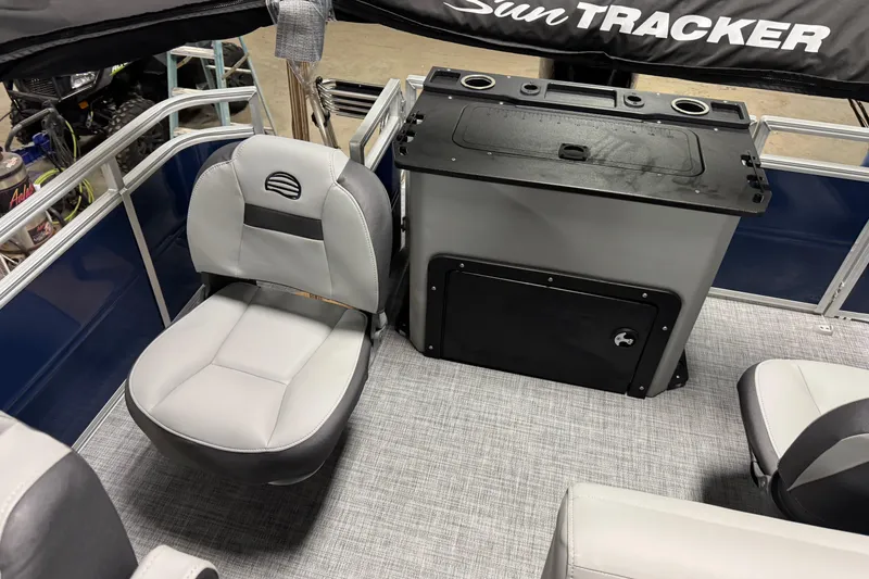 Slide: The Image of 2026 Sun Tracker SportFish 20 DLX interior with seating and storage unit. - 13