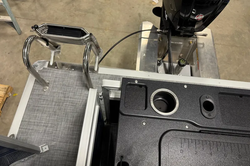 Slide: The Image of Sun Tracker SportFish 20 DLX 2026 boat deck with ladder and motor details. - 14