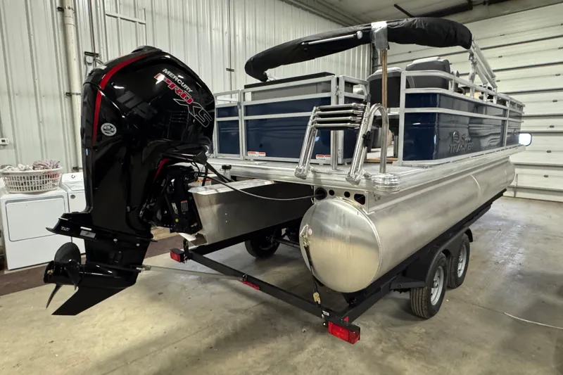 Slide: The Image of 2026 Sun Tracker SportFish 20 DLX pontoon boat with Mercury engine in a garage. - 3