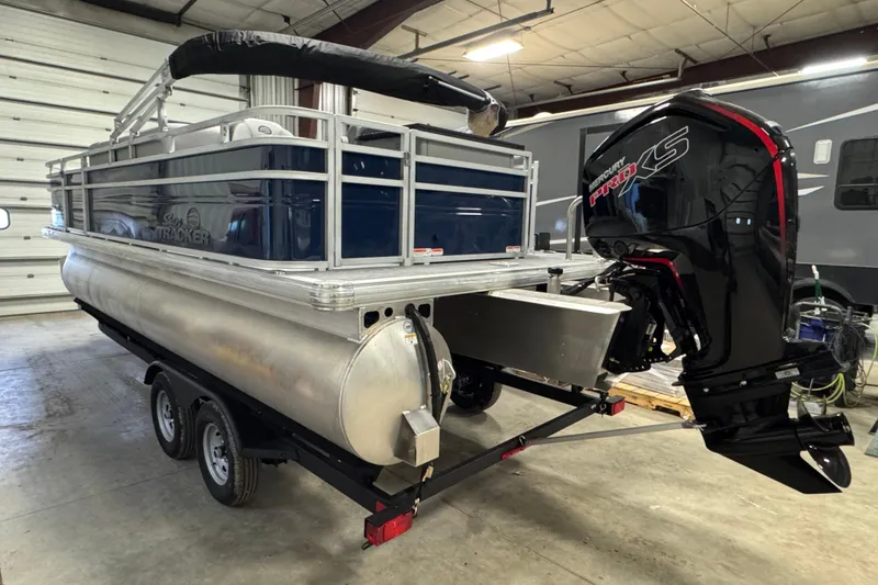 Slide: The Image of 2026 Sun Tracker SportFish 20 DLX pontoon boat with Mercury Pro XS engine in a garage. - 4
