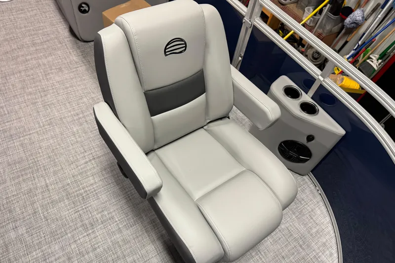 Slide: The Image of Luxurious seating on 2026 Sun Tracker SportFish 20 DLX pontoon boat, featuring cup holders and speaker. - 7