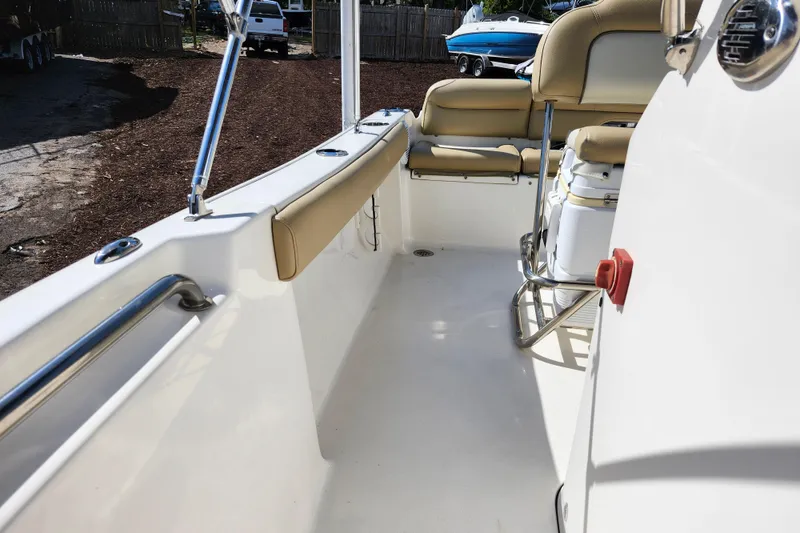 Slide: The Image of 2019 Key West 189 FS boat interior with beige seating and stainless steel fixtures. - 15