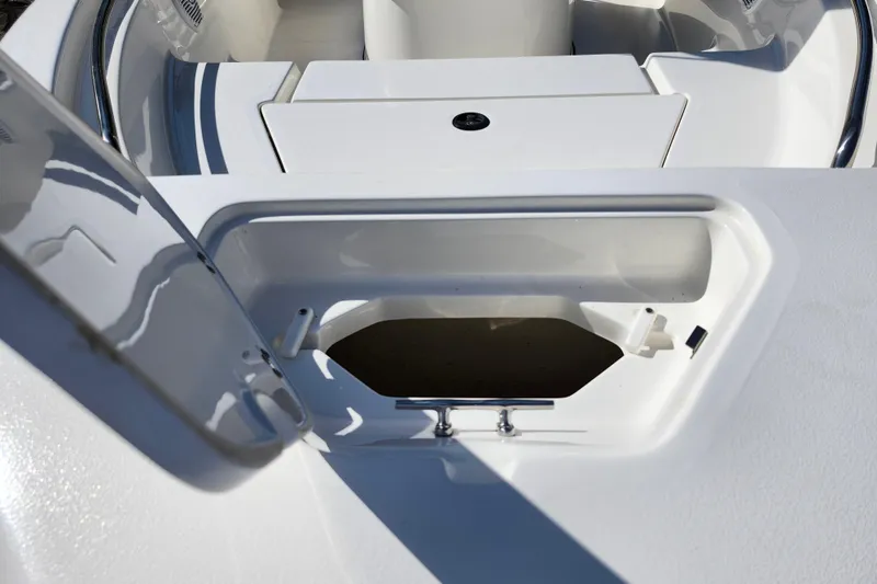 Slide: The Image of 2019 Key West 189 FS boat storage compartment with open lid, showcasing interior space. - 19