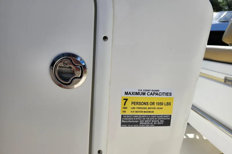 Slide: The Image of 2019 Key West 189 FS boat capacity label, showing maximum of 7 persons or 1050 lbs. - 27