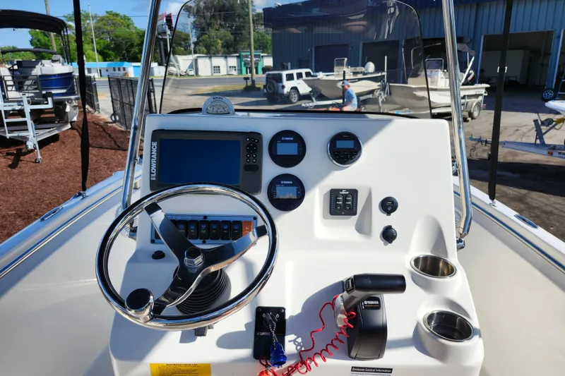 Slide: The Image of 2019 Key West 189 FS boat dashboard with steering wheel and navigation instruments. - 31