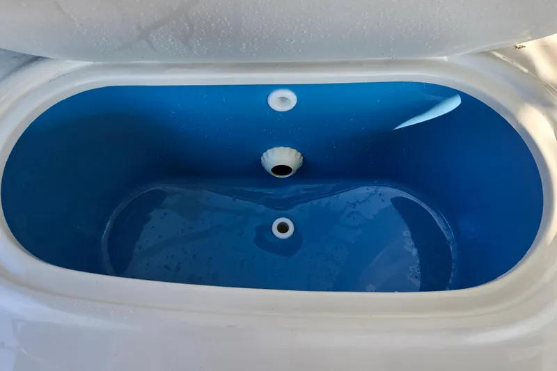 Slide: The Image of Livewell in 2019 Key West 189 FS boat, featuring a blue interior and drainage holes. - 35