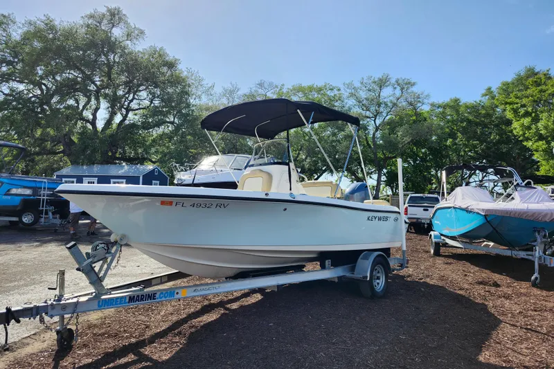 Slide: The Image of 2019 Key West 189 FS boat on trailer, parked outdoors under clear sky. - 6