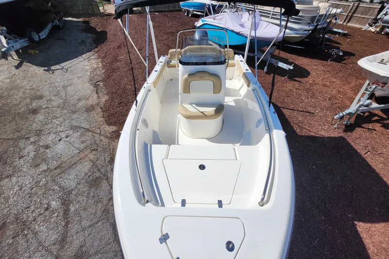 Slide: The Image of 2019 Key West 189 FS boat, white interior, parked outdoors on a sunny day. - 7