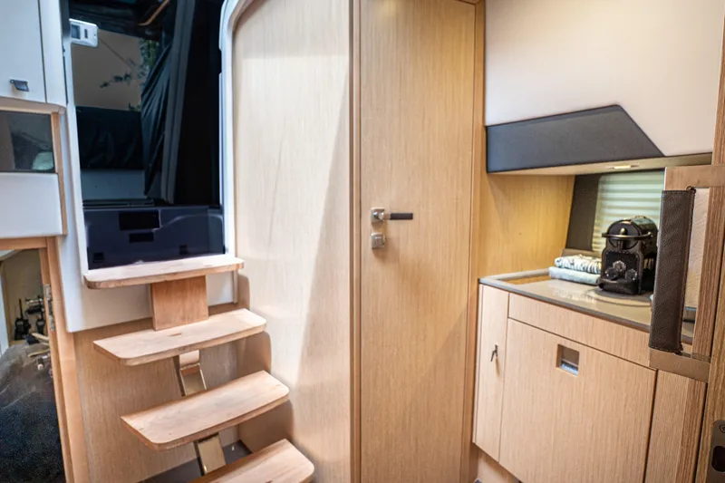 Slide: The Image of 2024 Fjord 41 XP interior with wooden stairs and modern cabinetry. - 21