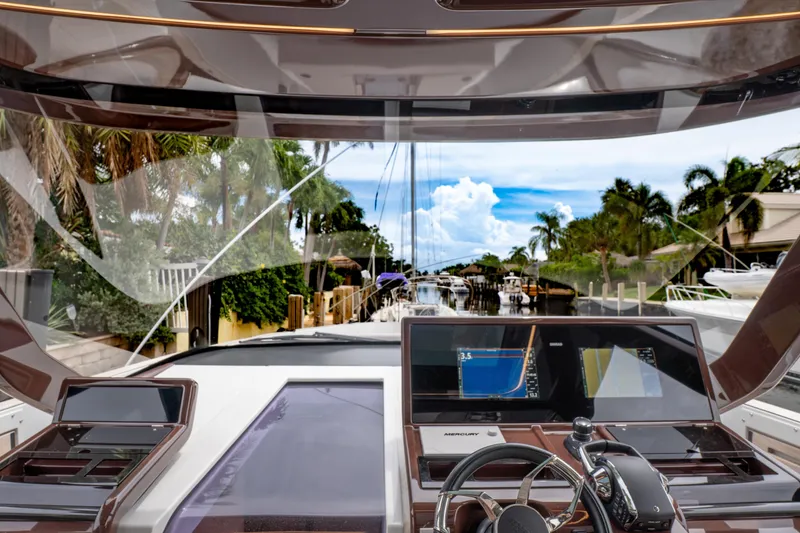 Slide: The Image of 2024 Fjord 41 XP yacht cockpit with advanced navigation screens and tropical canal view. - 10